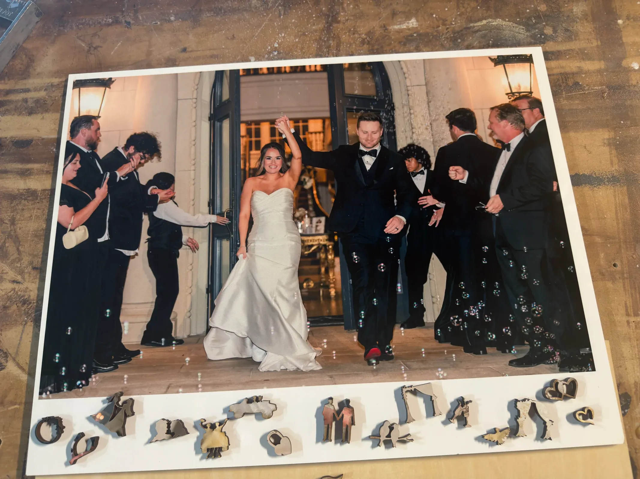 A completed Whittled wedding puzzle with personalized pieces arranged beneath the photograph